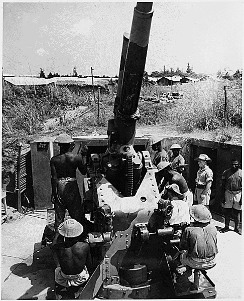 British soldiers teach African natives how to operate a 3.7cm anti-aircraft gun